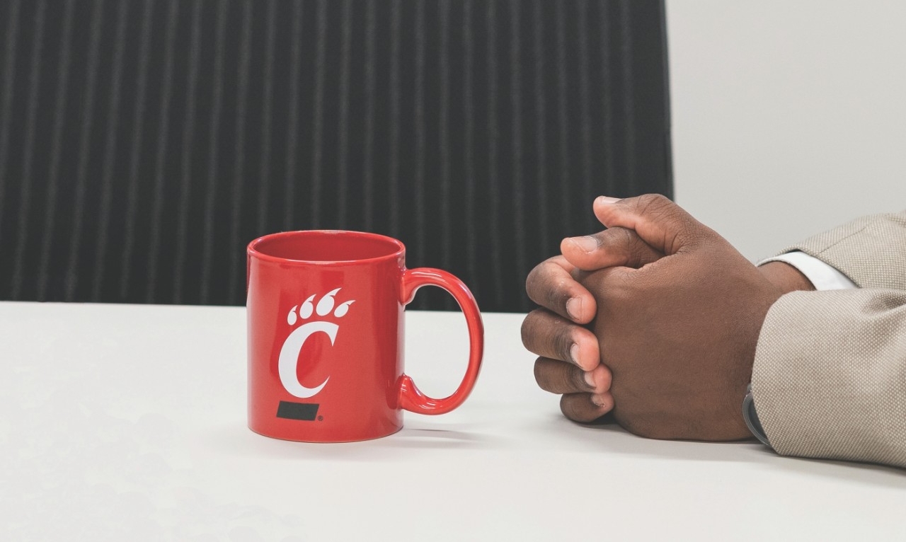 Alumnus cheers during football game