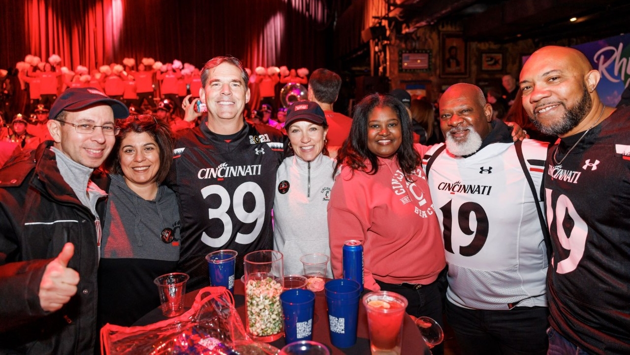 Alumni smiling at the Wasabi Fenway Bowl pregame event
