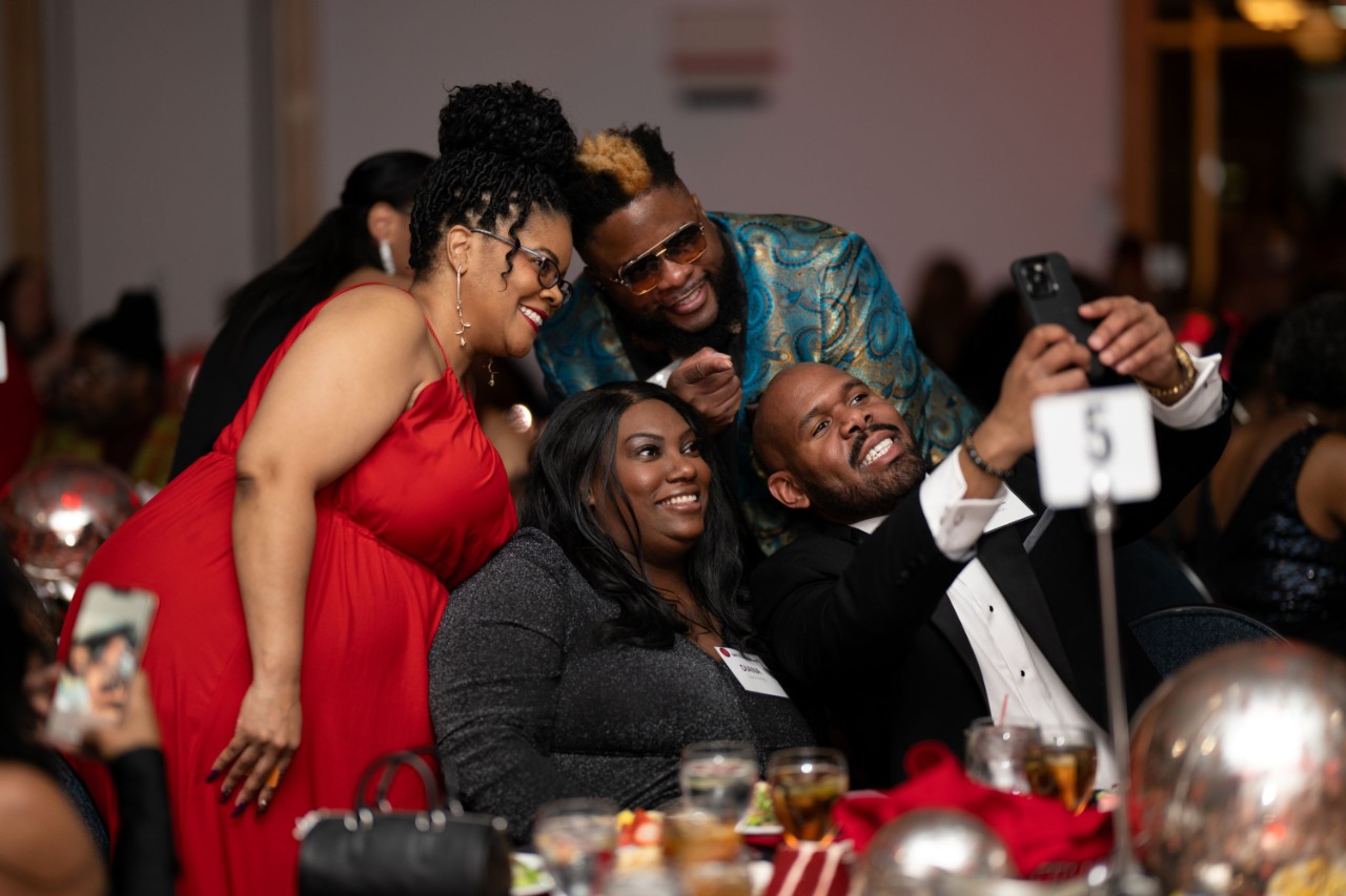 alumni taking a selfie at an event