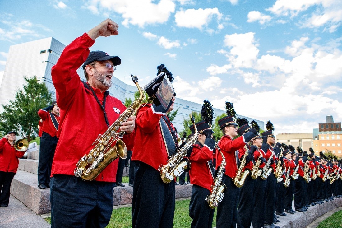 UC Bearcat Band playing on field at a football game