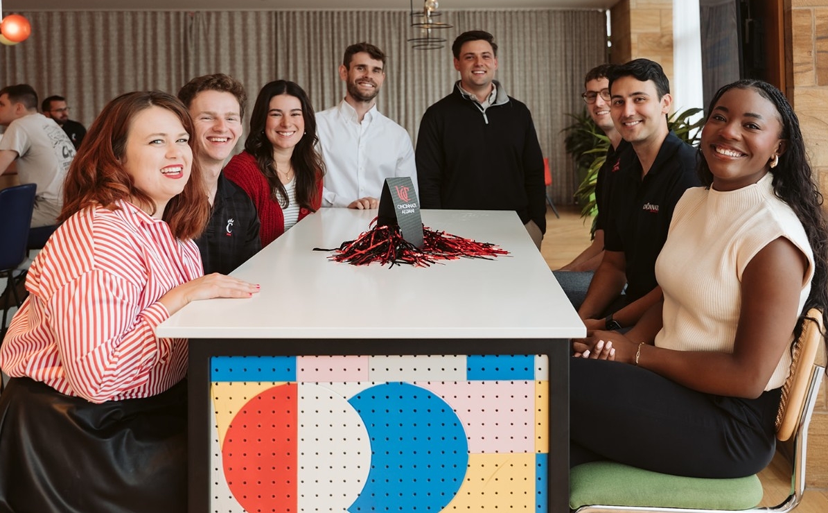 Young Professionals smiling while sitting around a table