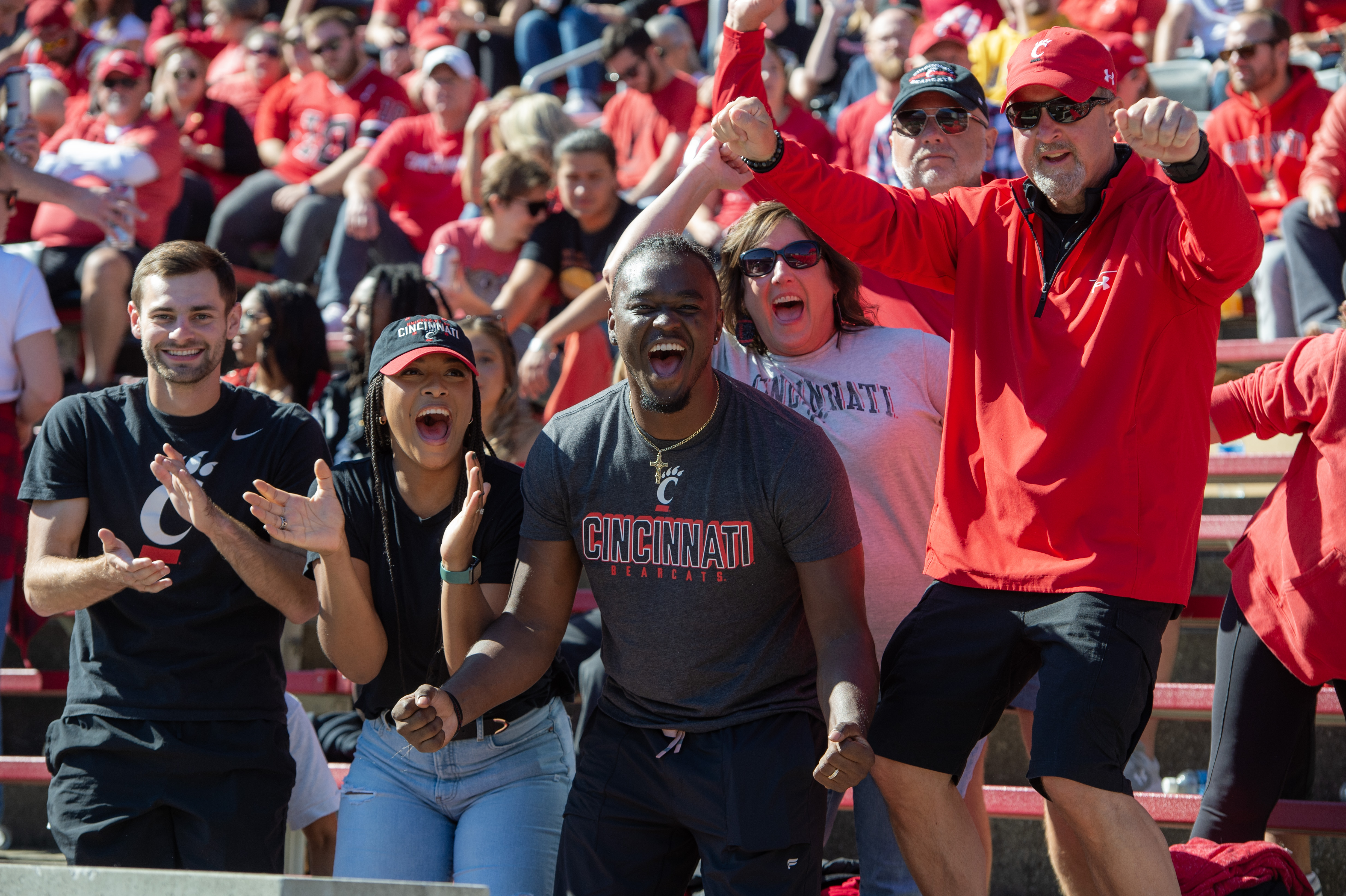 People cheering in stands at a football game