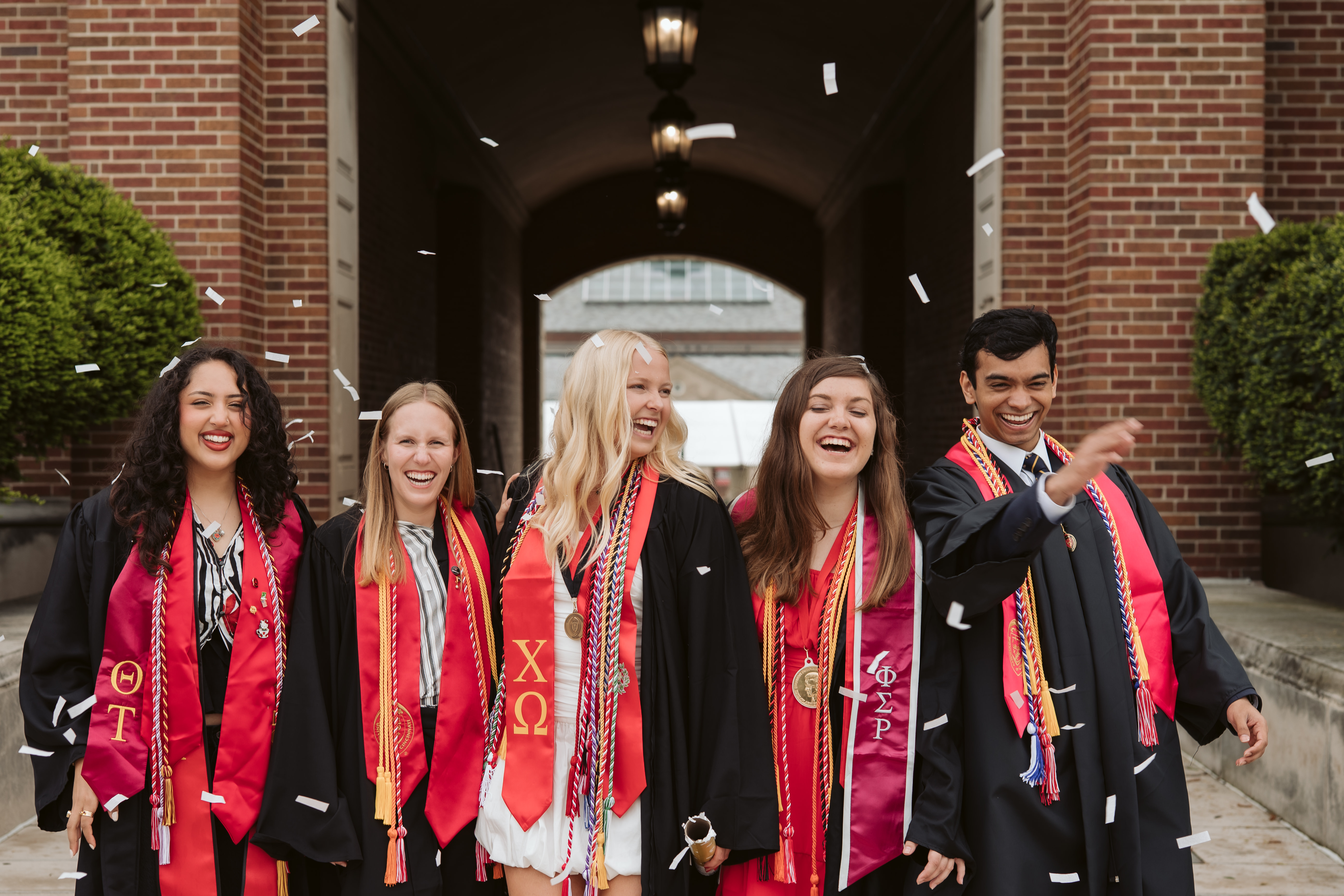 Group of New Grads smiling in their cap and gown