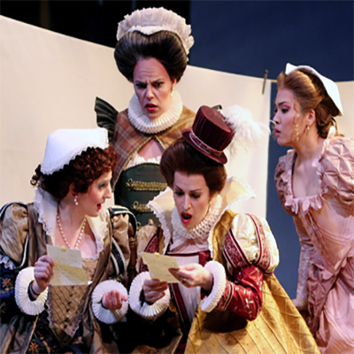 Four CCM students act on stage in costume